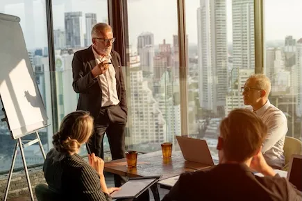 Client advisors working in an office with a city skyline view